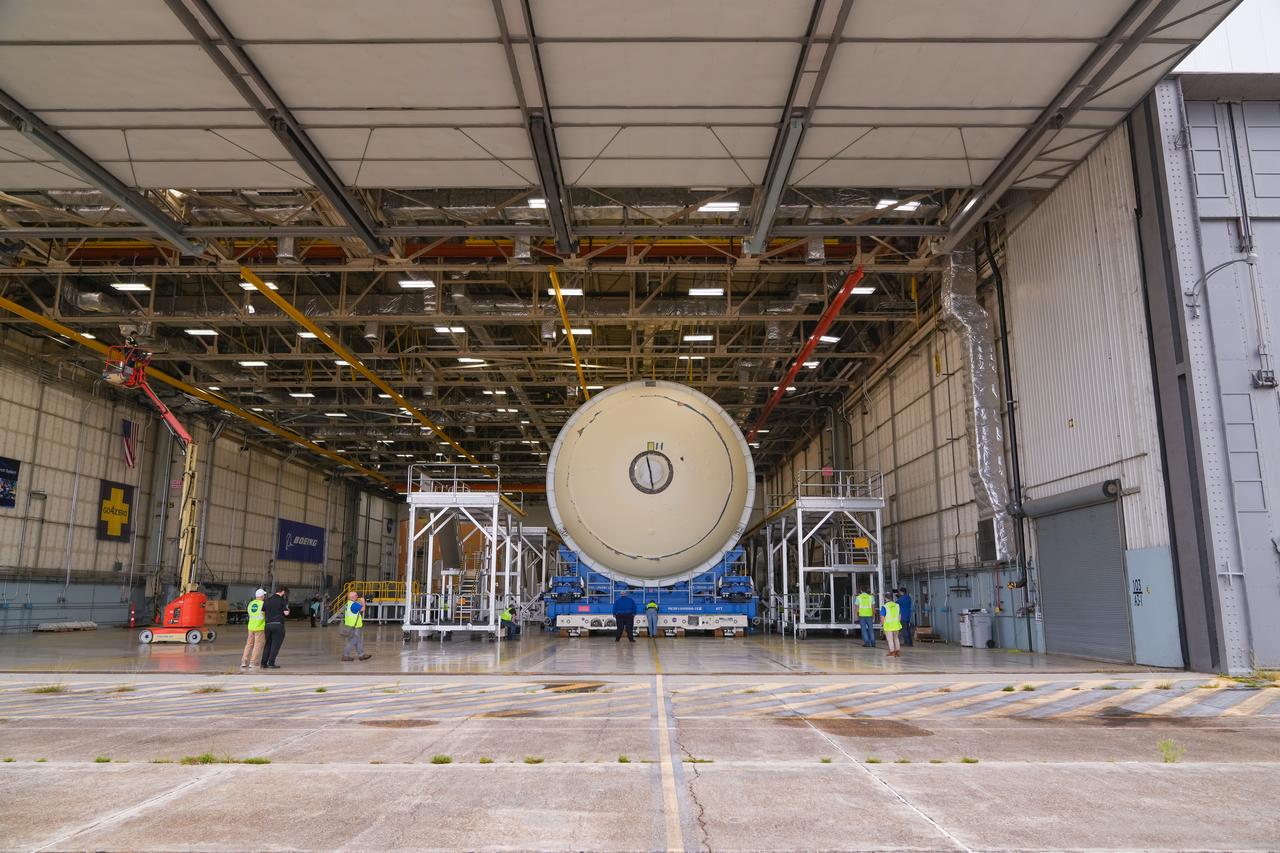 Teams at NASA’s Michoud Assembly Facility in New Orleans move a liquid hydrogen tank for the agency’s SLS (Space Launch System) rocket into the factory’s final assembly area on April 22. Having recently completed application of the thermal protection system, teams will now continue outfitting the 130-foot-tall tank with critical systems to ready it for its designated Artemis III mission. The propellant tank is one of five major elements that make up the 212-foot-tall rocket stage. The core stage, along with its four RS-25 engines, produce more than two million pounds of thrust to help launch NASA’s Orion spacecraft, astronauts, and supplies beyond Earth’s orbit and to the lunar surface for Artemis.